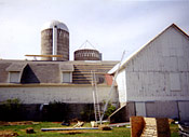 Early stage of barn roof replacement using Amish craftsmanship and modern tools